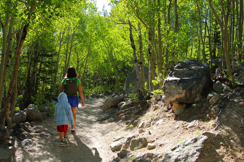 Alex tags behind Mom, walking uphill.