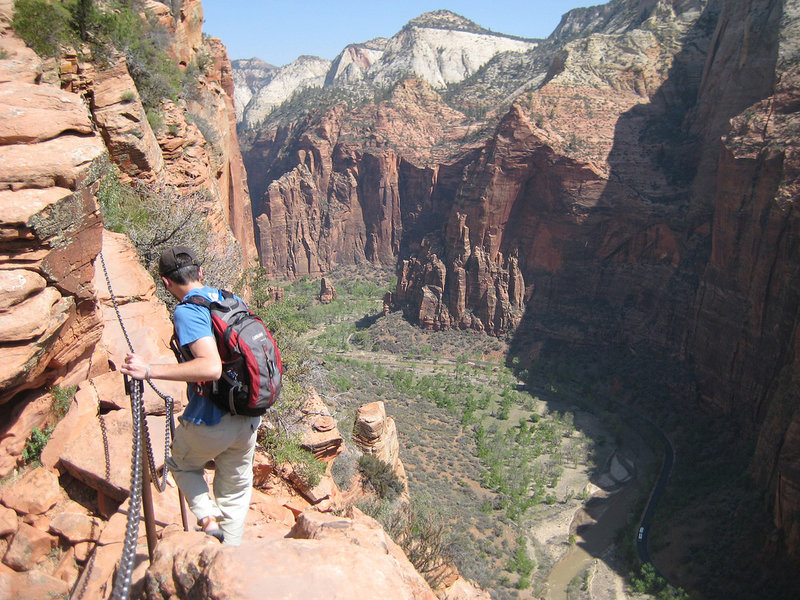 An interpid hiker descends the Angels Landing route with near 1000 foot drops on both sides. NPS Photo/Caitlin Ceci