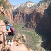 An interpid hiker descends the Angels Landing route with near 1000 foot drops on both sides. NPS Photo/Caitlin Ceci