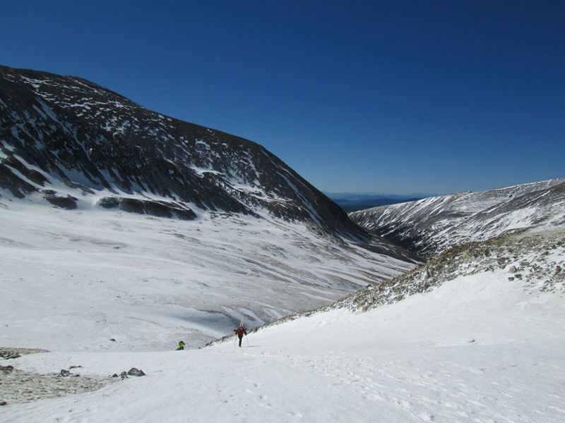 A hiker/skier working toward the fun part of this climb: a spring ski descent.