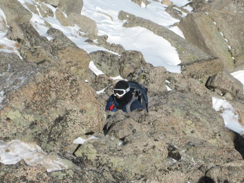 A hiker scrambles on some Sawatch rock on a cold winter day.