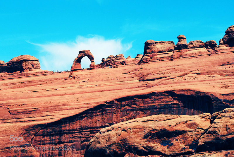 A view of arches and visitors from the canyon floor.