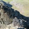 A hiker approaches the summit block. The technical formation behind him is not a part of this hike. There are many excellent scrambling options in this area. Have fun, but be careful!