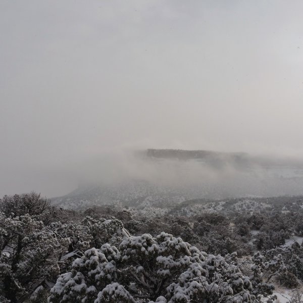 The clouds like fog across the plateau.  On the Monument Valley Trail