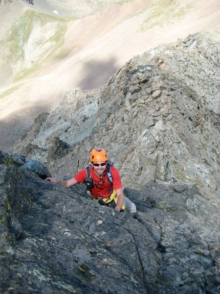 A climber on the start of the crux wall, just below the crack in the next picture. Easier scrambling can be seen behind him.