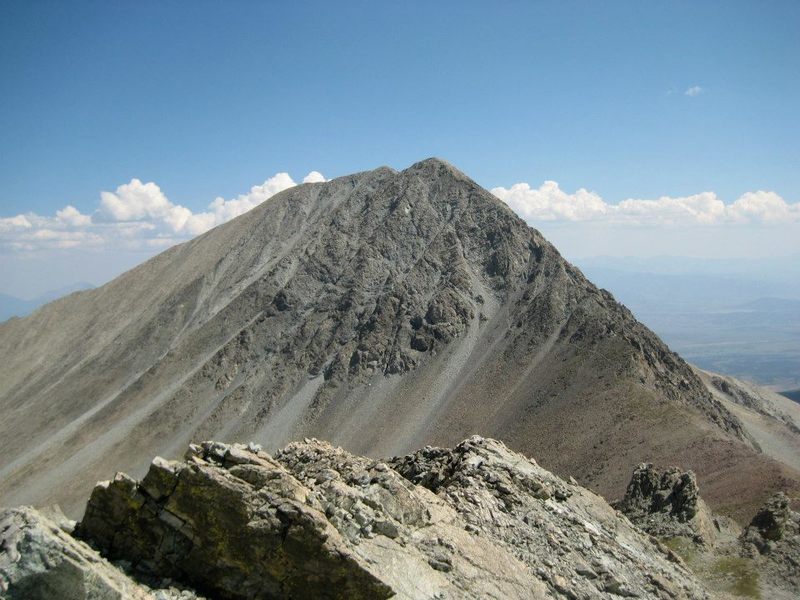 Taken from the summit of nearby 13er Iron Nipple, this picture shows Mt. Lindsey Trail leading up into the gully. The alternative ridge can also be seen on the right side of the mountain.