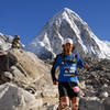 An elite runner making their way down a tight section of singletrack.