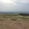 The view from the top of the mountain, a long way traveled with the radio tower and service road visible.