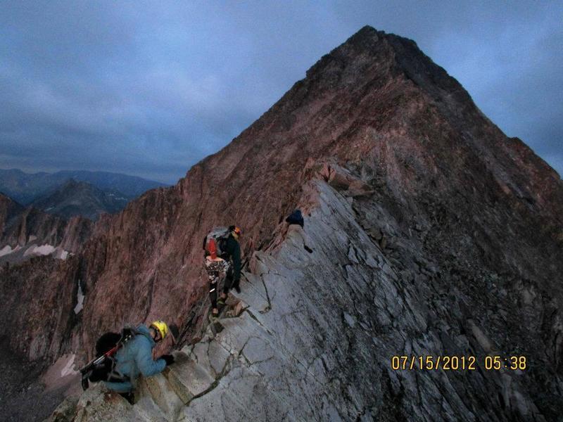 Crossing the knife edge at sunrise, with Capitol Peak looming ahead.