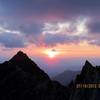 Taken from across the knife edge, this picture shows a hiker on top of K2, with a stunning sunrise behind him.