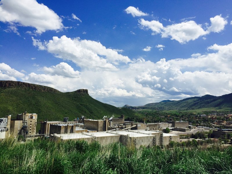 A gorgeous blue-sky vista looking south over Golden from the trailhead of the North table Mountain climbing access Trail with the Coors Brewery and Golden's Castle Rock in view.