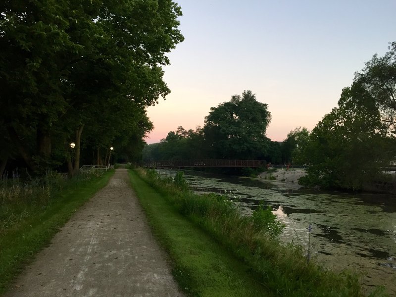 Section of trail in Morris.  Notice the footbridge connecting to the neighborhood on the other side of the canal.