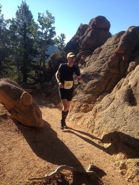 Still below treeline nearly halfway to Pikes Peak summit, a runner enjoys a short mellow section of Barr Trail with some funky formations. Photo by Nancy Hobbs