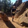 Still below treeline nearly halfway to Pikes Peak summit, a runner enjoys a short mellow section of Barr Trail with some funky formations. Photo by Nancy Hobbs