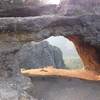 A view into the wind caves from the entrance, with Logan Canyon showing down below