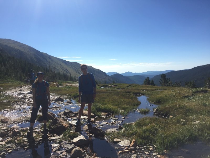 Working our way over one of the soggier areas of Arapaho Pass Trail.