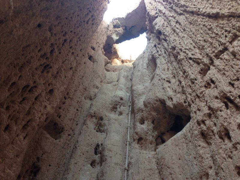 A rope that leads up and under a natural bridge in the back of one of the slot canyons in the Moon Caves section of the park (to access this, you need to crawl through a small underground passage that then opens up into this canyon)