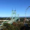 The lower end of the Ridge Trail offers a stunning view of the St. Johns Bridge and the Cascade Range. Mt. St. Helens can be seen on the left side of the bridge and Mt. Adams on the right.