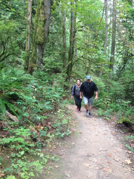 Two people walk up the Cannon Trail, which connects the parking lots of the Wildwood and Leif Erikson trailhead parking lots.