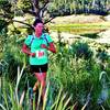 A happy runner enters the trail by the information kiosk.