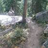 A huge cairn marks the top of the steep stone stairs up from the creek