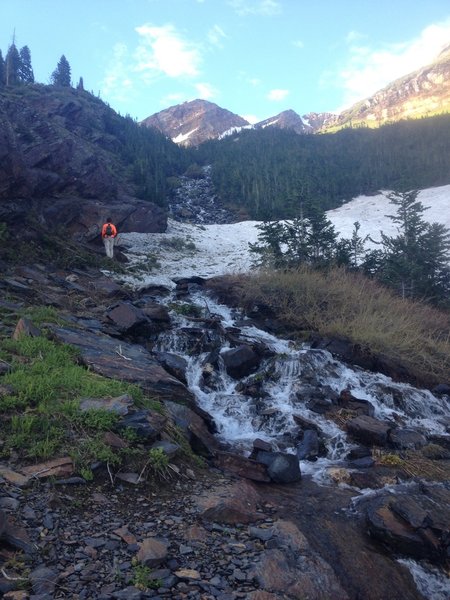 Snow patches turn to a meltwater stream before our eyes in late June.