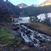 Snow patches turn to a meltwater stream before our eyes in late June.