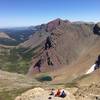 Three friends taking a minute to take in the view from the summit of Siyeh Pass.