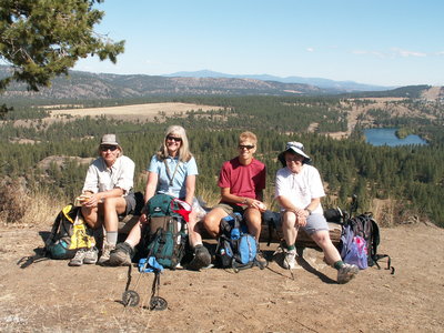 Hikers enjoying the bench with the view at the top of Pine Bluff.  Spokane River in the distance.