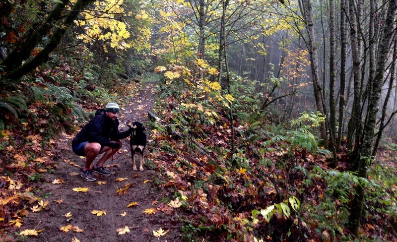 A runner pauses with his dog on Fire Lane 2.