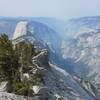 Westward view of Yosemite Valley, Half Dome, Tenaya Canyon, and smoke from fires from Clouds Rest.