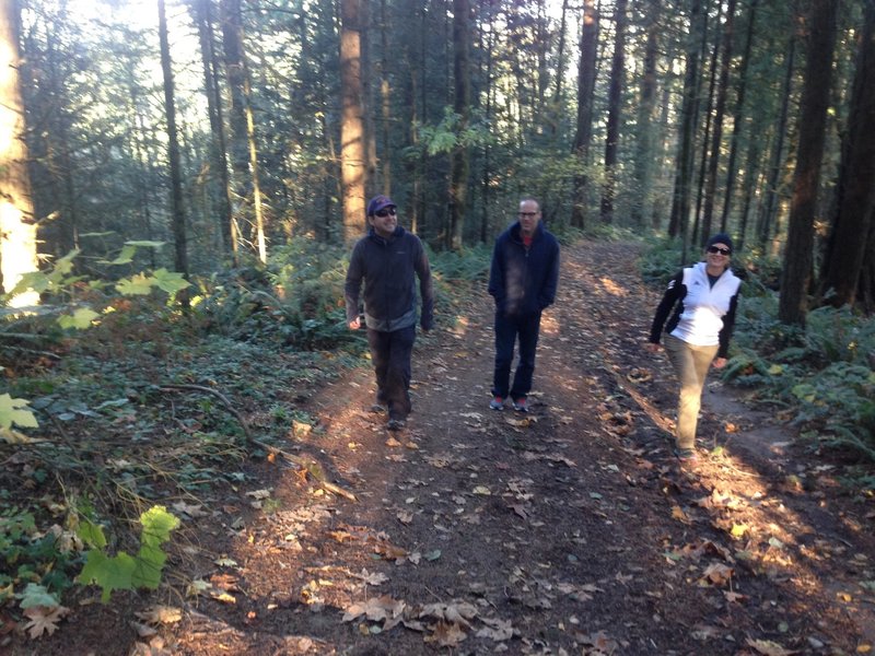 Three hikers out for a fall afternoon on the upper section of Fire Lane 5.