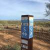 Trail marker with Code, GPS coordinates, and elevation info.