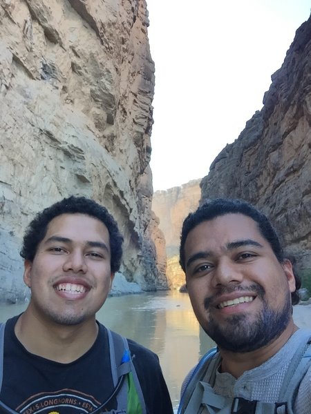 Standing on a rock in the middle of the Rio grande river, in Santa Elena Canyon trail at Big bend national park.