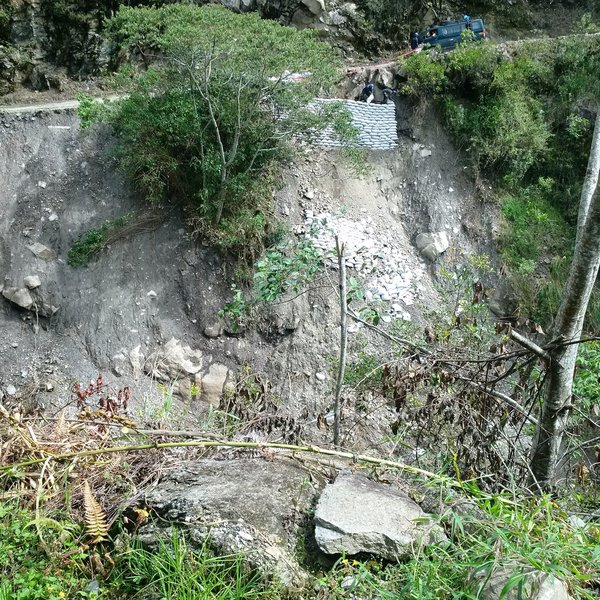 Road maintenance. All the sandbags that have slipped down the slope suggest it's a constant work in progress.