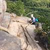 Using the iron rungs to get up to the next level on the Beehive Trail.