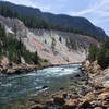 Looking up the Yellowstone River from Seven Mile Hole. The black stains on the right side of the canyon are from small hot springs seeping into the river.