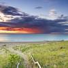 A solitary person sitting on the washed up tree. An amazing Lake Michigan sunset mixed with an impending thunderstorm. Incredible colors. Photo taken in between the Dunbar and Lakeview parking lots at Derby Ditch.