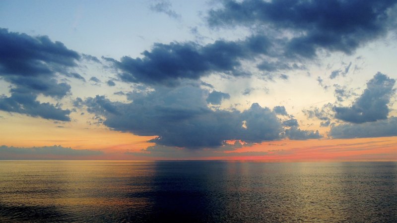 A rare, perfectly calm Lake Michigan at sunset. Killer colors.