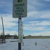 The first sign showing how to get to trail, not far from parking lot, just after crossing the street.