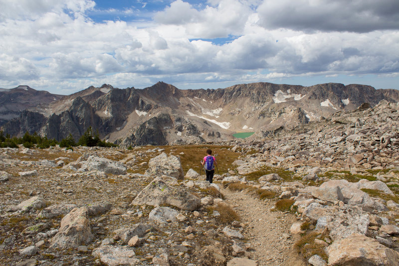 Hiker and Mica Lake along trail descending from Paintbrush Divide.