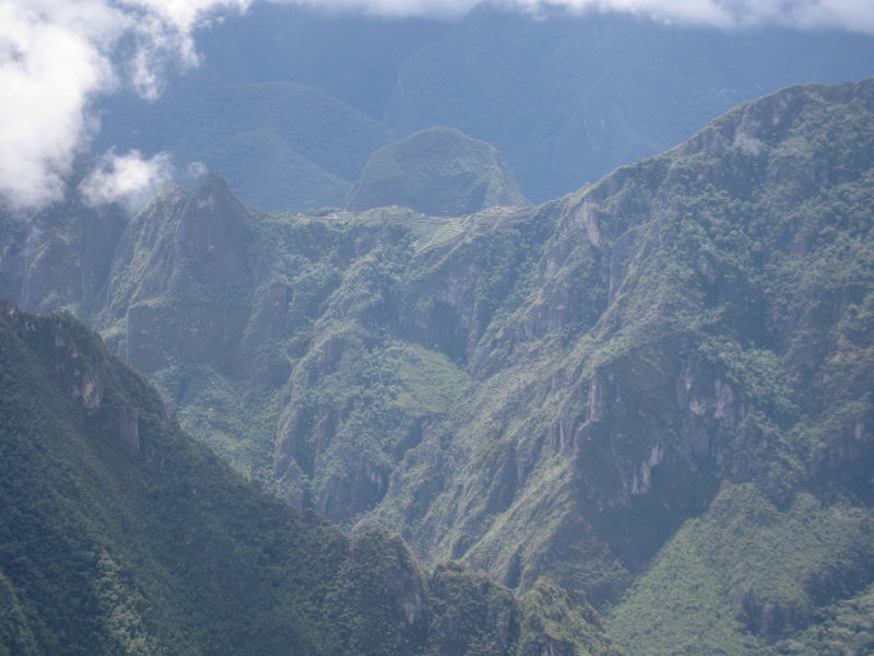One of the reasons people take the Salkantay route to Machu Picchu is that you get a unique view of the ruins that few people see. Here, in the upper middle section of the photo, is our first view of Machu Picchu. You can see the terracing on the downslope.