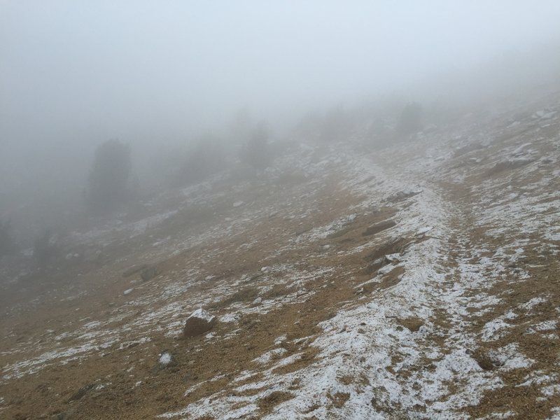 Fog drifts over the trail approaching Cathedral Pass.