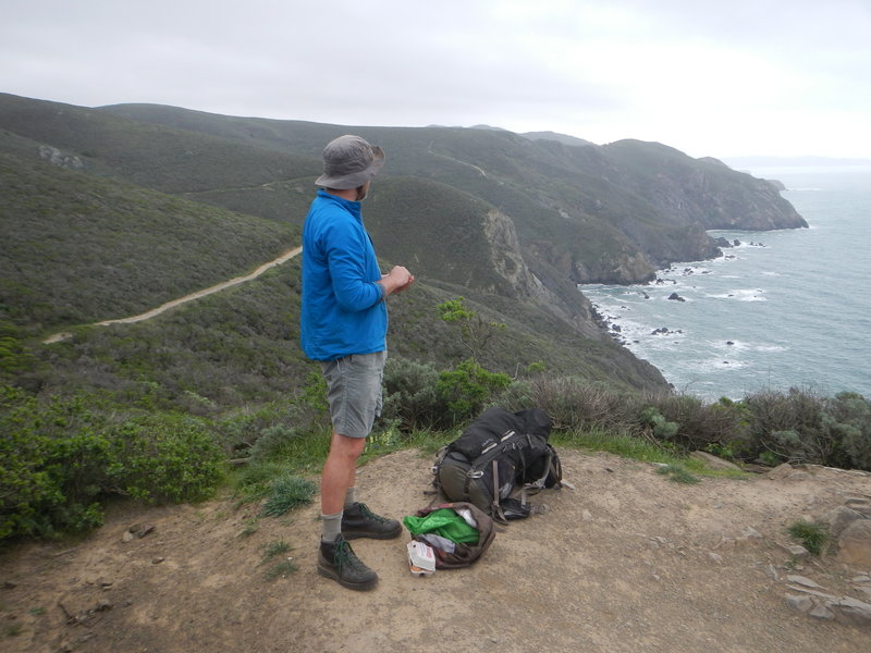 Northward bound backpacker taking in the view with his morning snack.