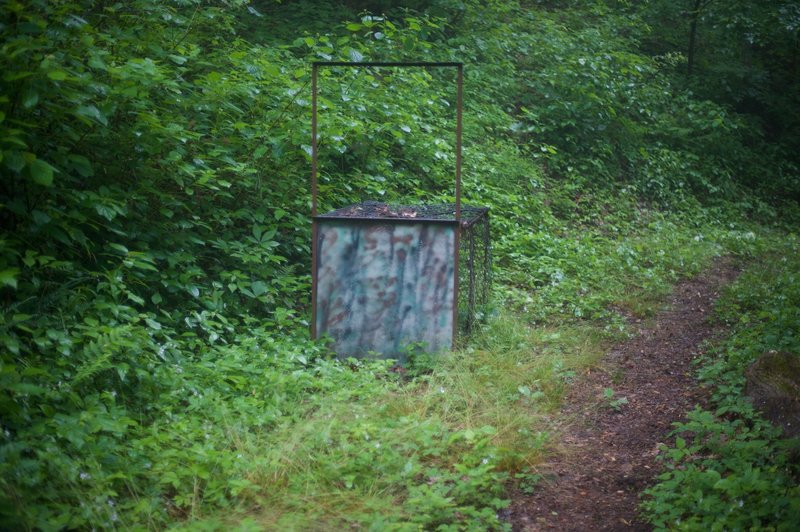 Wild hog trap sitting alongside the trail.