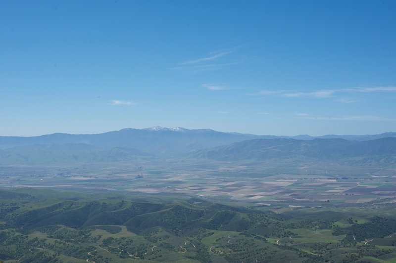 A view toward the west, with farmland and mountains in the distance.