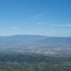 A view toward the west, with farmland and mountains in the distance.