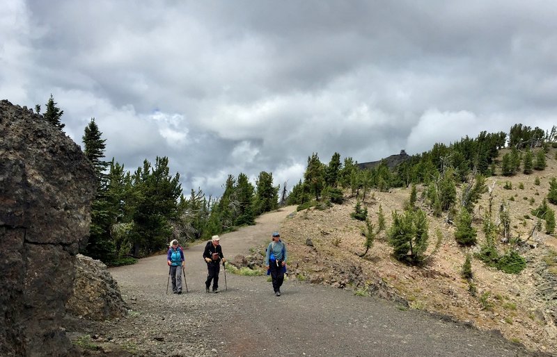 Hikers returning from a rewarding trip to the top of Mount Washburn (the Washburn Fire Lookout is visible on the upper right).