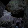 Rocks that have to be climbed over in the cave.  You can notice the creek running through the cave.