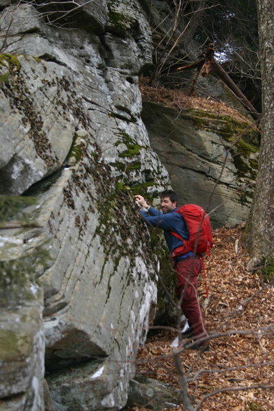 Looking for chutes to climb in order to ascend the cliffs up to the summit of Friday. No ice on the south facing side!